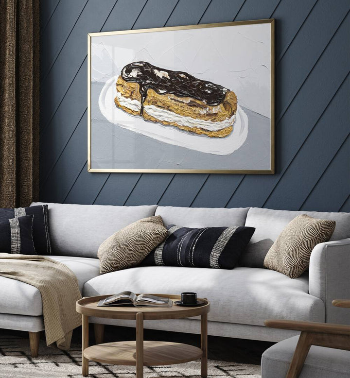 Chocolate Eclair by Alice Straker Cafe Art Prints Cafe Posters in Gold Plain Frame placed on a living room wall behind a sofa