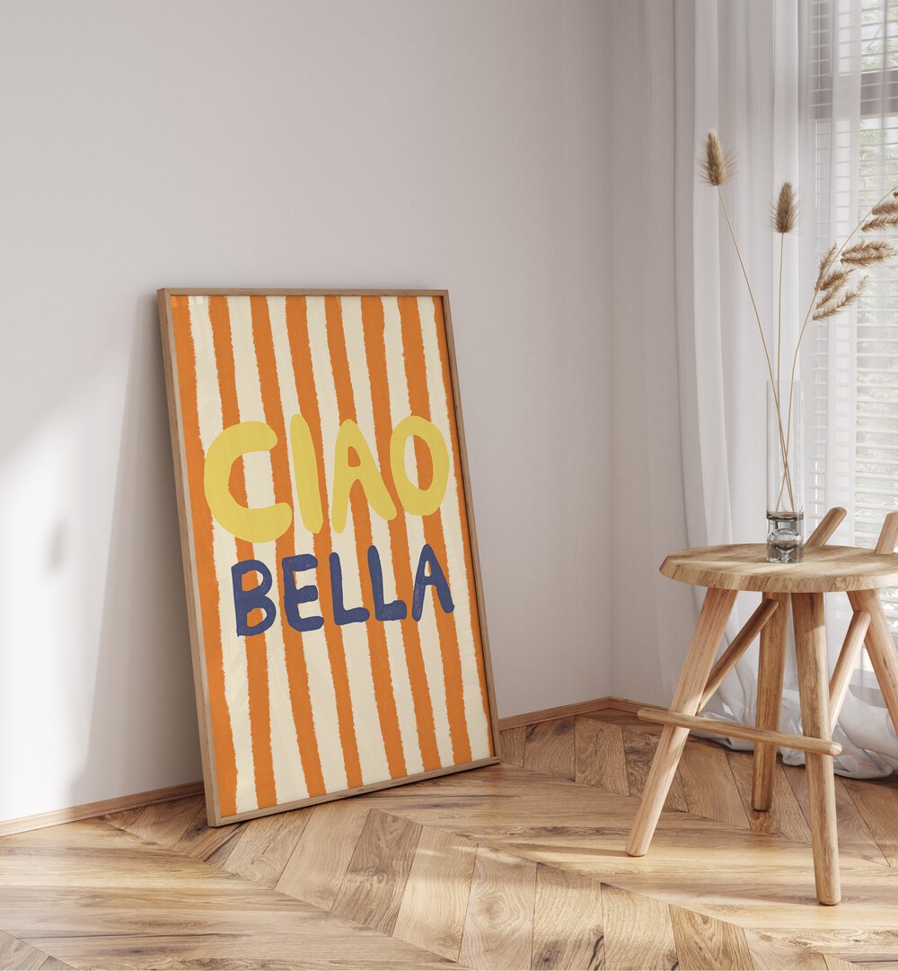 Ciao Bella ii by Studio Dolci Quotes Art Prints in Oak Wood Plain Frame placed on a floor beside a table