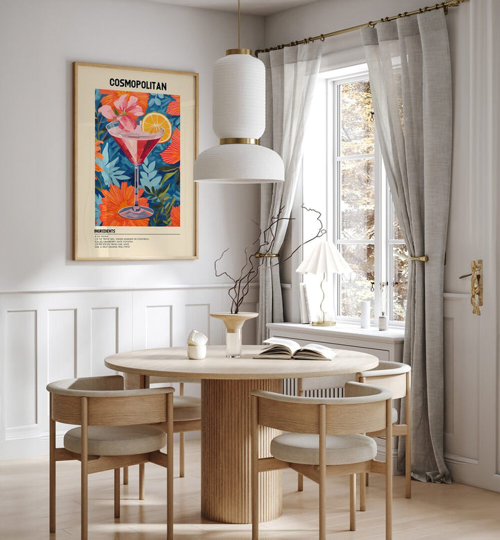 City Lights in a Glass Cosmopolitan Cafe Art Prints Cafe Posters in Oak Wood Plain Frame placed on a wall in a dining room area beside a window and behind a dining table