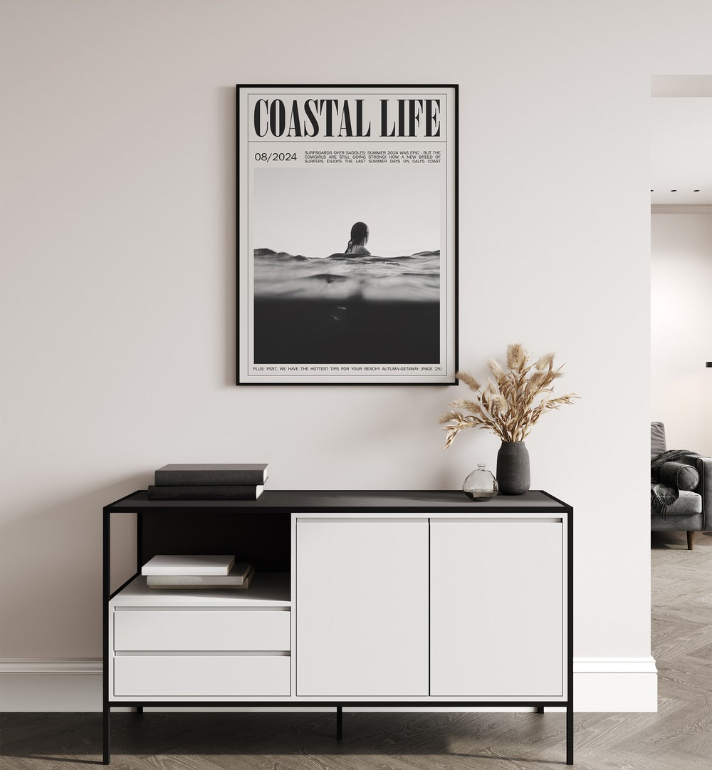 Coastal Life Iv Beach Prints Coastal Wall Art in Black Plain Frame placed on a wall behind a black and white table