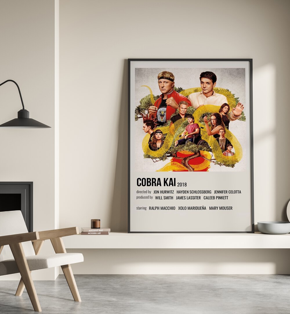 Cobra Kai 2018 Movie Posters in Black Plain Frame place on a wall behind a chair beside lamp