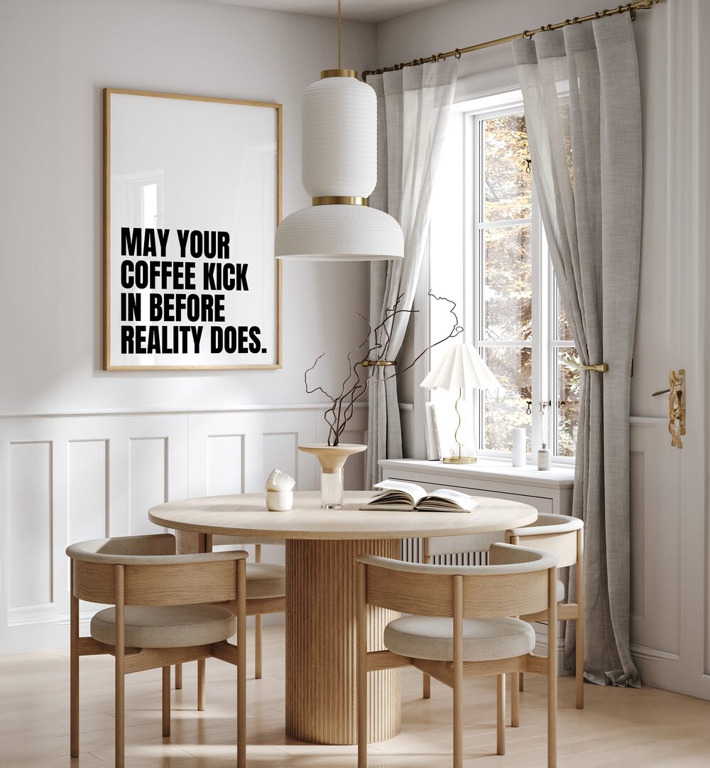 Coffee Kick by Athene Fritsch Quotes and Typography Posters in Oak Wood Plain Frame placed on a wall in a dining room area beside a window and behind a dining table