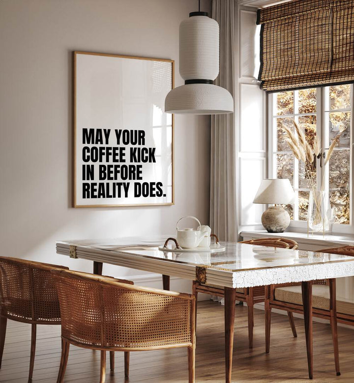 Coffee Kick by Athene Fritsch Quotes and Typography Posters in Oak Wood Plain Frame placed on a wall in a dining room area beside a window and behind a dining table