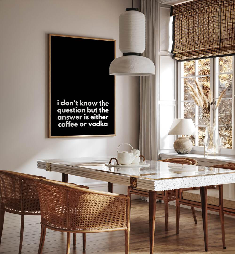 Coffee or Vodka by Athene Fritsch Quotes and Typography Posters in Oak Wood Plain Frame placed on a wall in a dining room area beside a window and behind a dining table