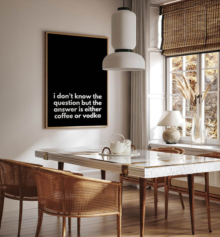 Coffee or Vodka by Athene Fritsch Quotes and Typography Posters in Oak Wood Plain Frame placed on a wall in a dining room area beside a window and behind a dining table