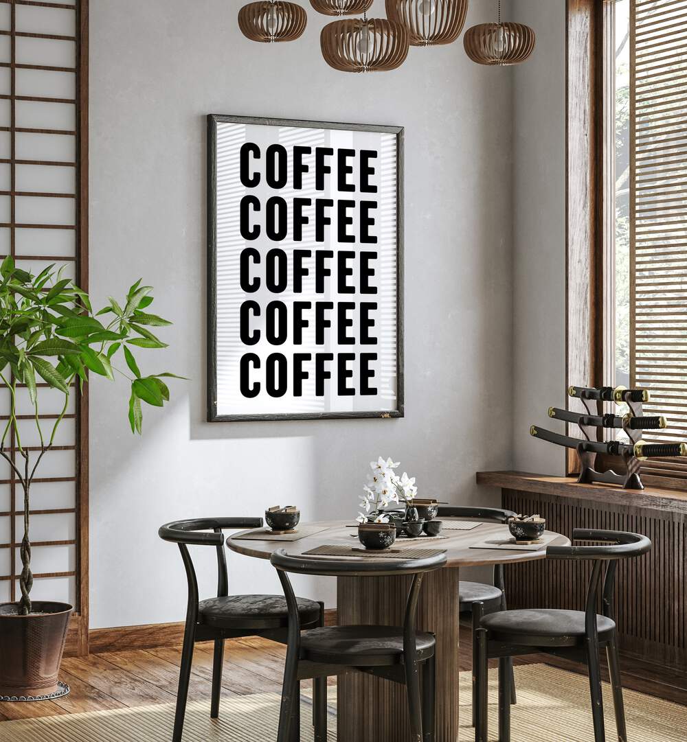 Coffeee by Athene Fritsch Quotes and Typography Posters in Black Plain Frame placed on a wall in a dining room area beside a window and behind a dining table