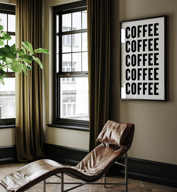 Coffeee by Athene Fritsch Quotes and Typography Posters in Black Plain Frame placed on a living room wall behind a chair and beside a window