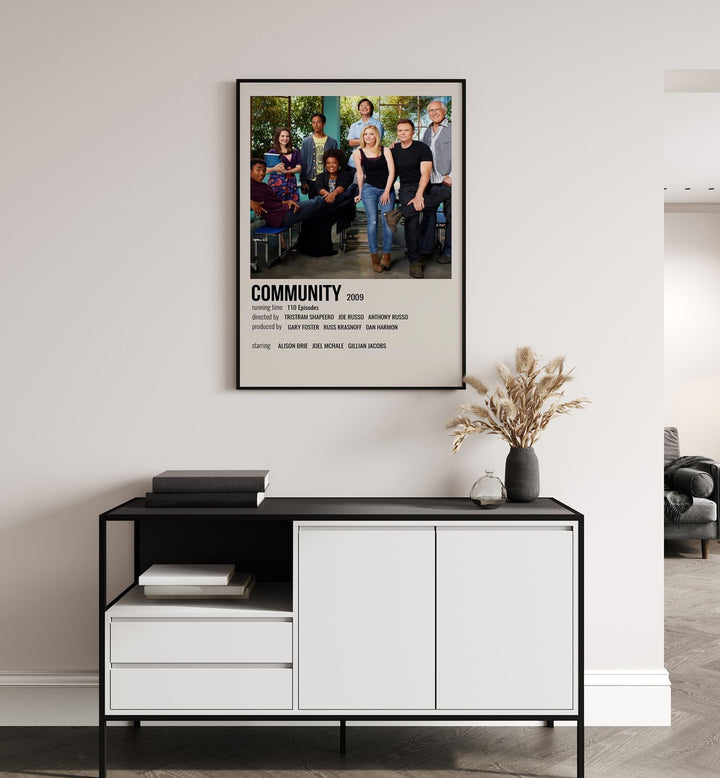 Community 2009 Movie Posters in Black Plain Frame hanging on wall above console table