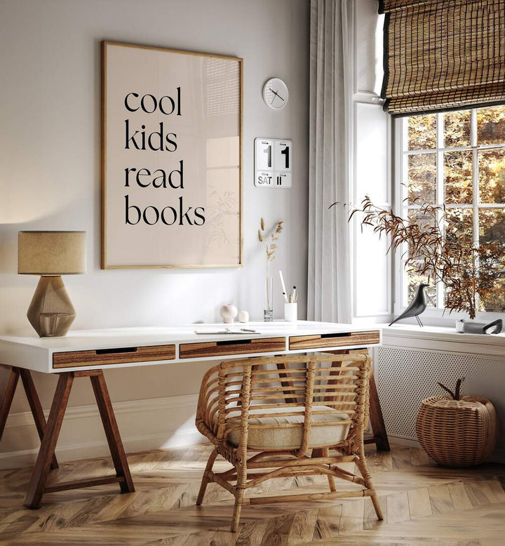 Cool Kids Read Books by Anne-marie Volfova Quotes and Typography Posters in Oak Wood Plain Frame placed on a wall behind a study table and beside a window