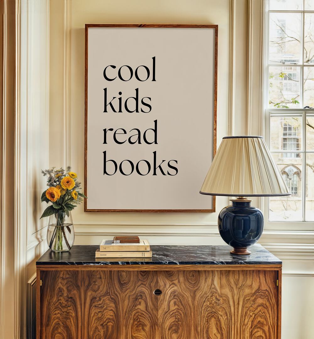 Cool Kids Read Books by Anne-marie Volfova Quotes and Typography Posters in Dark Wood Plain Frame behind a table and beside a window