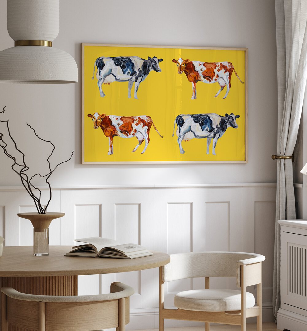 Cow Art on Yellow by Alice Straker Wildlife Paintings Wildlife Posters in Oak Wood Plain Frame placed on a wall in a dining room area beside a window and behind a dining table