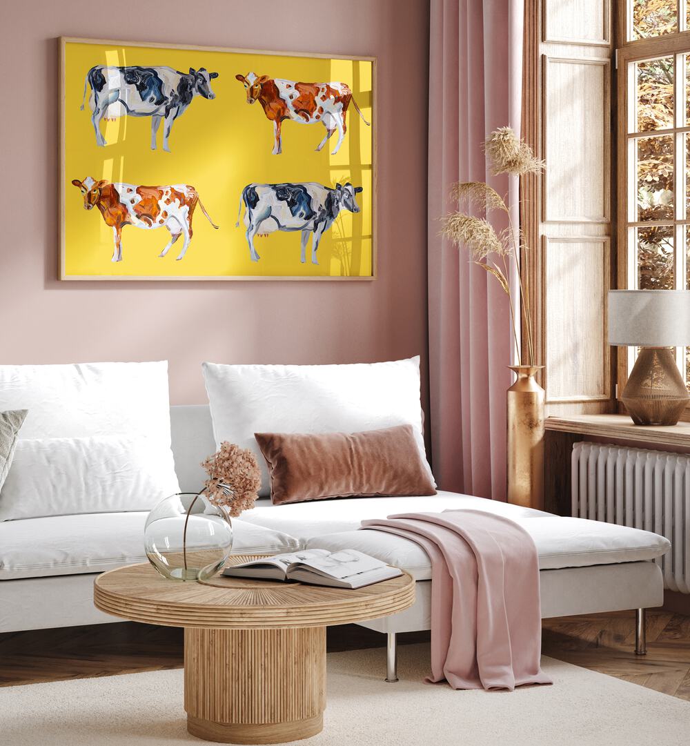 Cow Art on Yellow by Alice Straker Wildlife Paintings Wildlife Posters in Oak Wood Plain Frame placed on a living room wall behind a sofa and beside a window