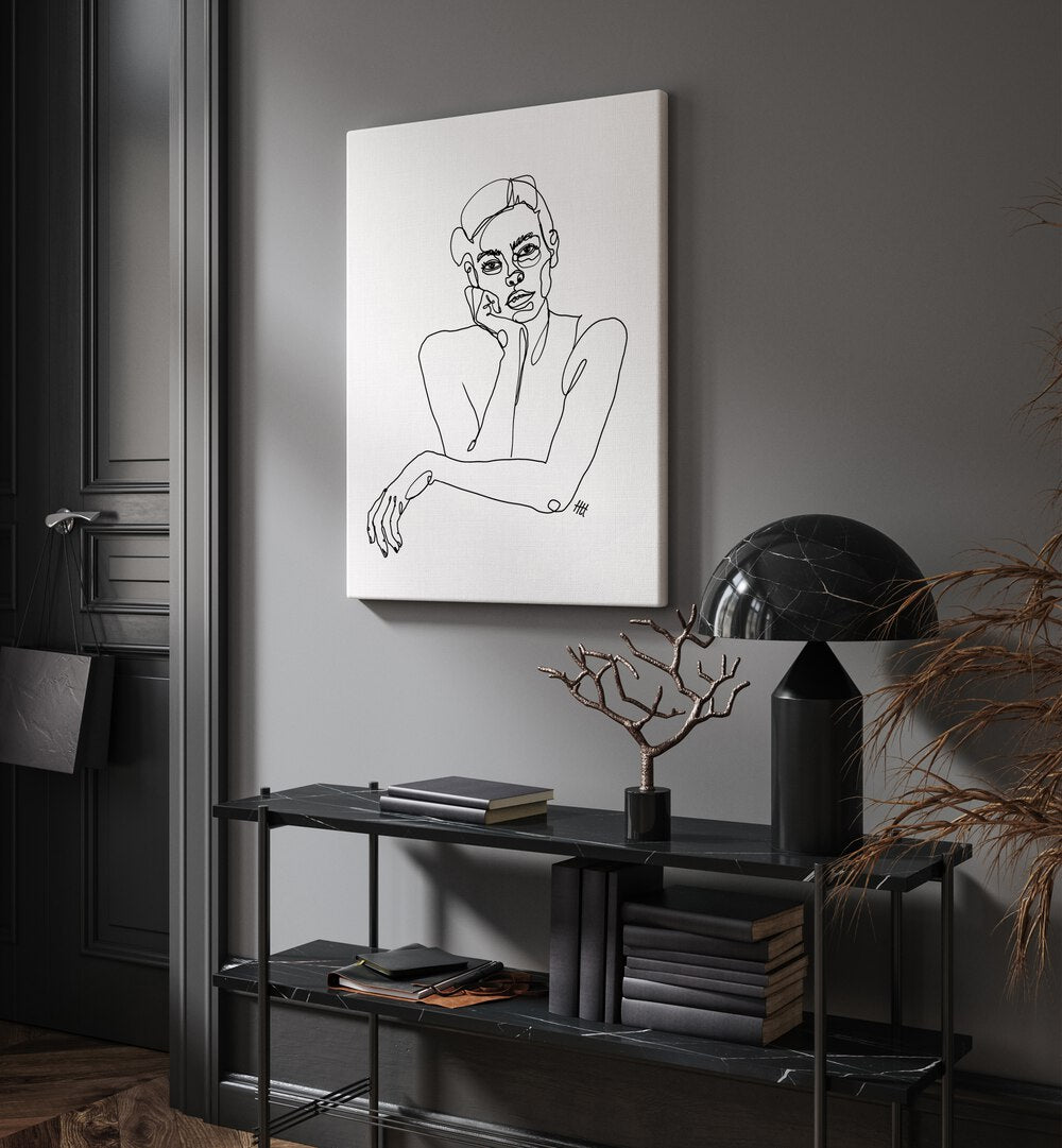 Curious by Hanna Lee Tidd Line Art Paintings Line Art Prints in Gallery Wrap placed on a wall behind a black table and beside a door