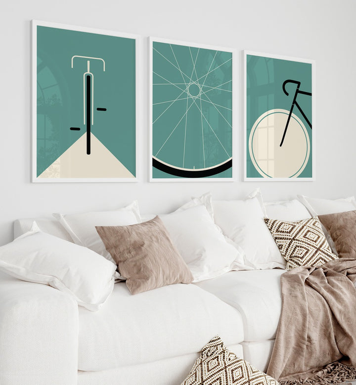 Cycle Set Set Of 3 Paintings in White Plain Frame placed on a living room wall behind a sofa