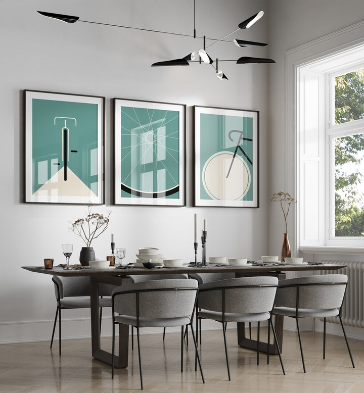 Cycle Set Set Of 3 Paintings in Black Frame With Mount placed on a wall behind a dining table and beside a window for dining area