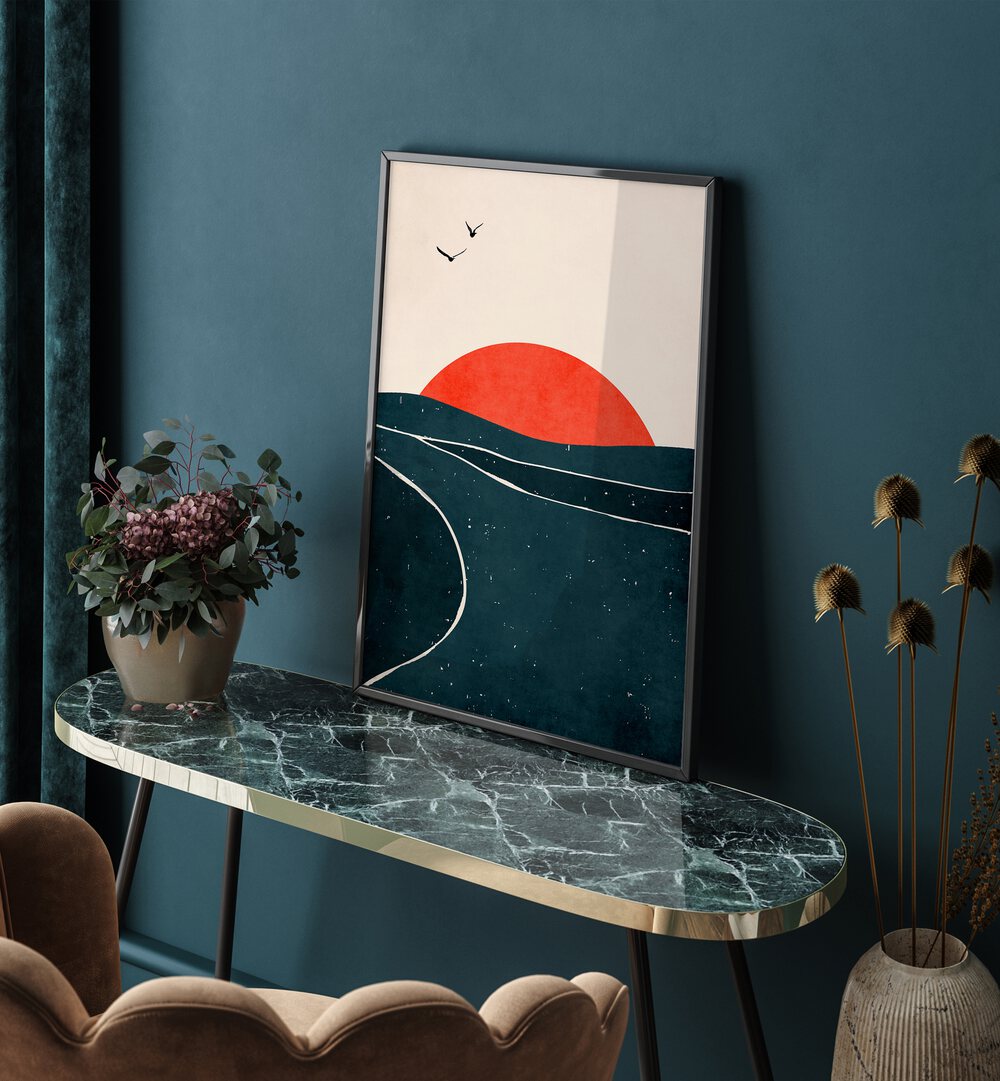 Dancing Seagulls Landscape Art Artwork in Black Plain Frame Placed on a Graphite Side Table next to A Blue Colored Wall