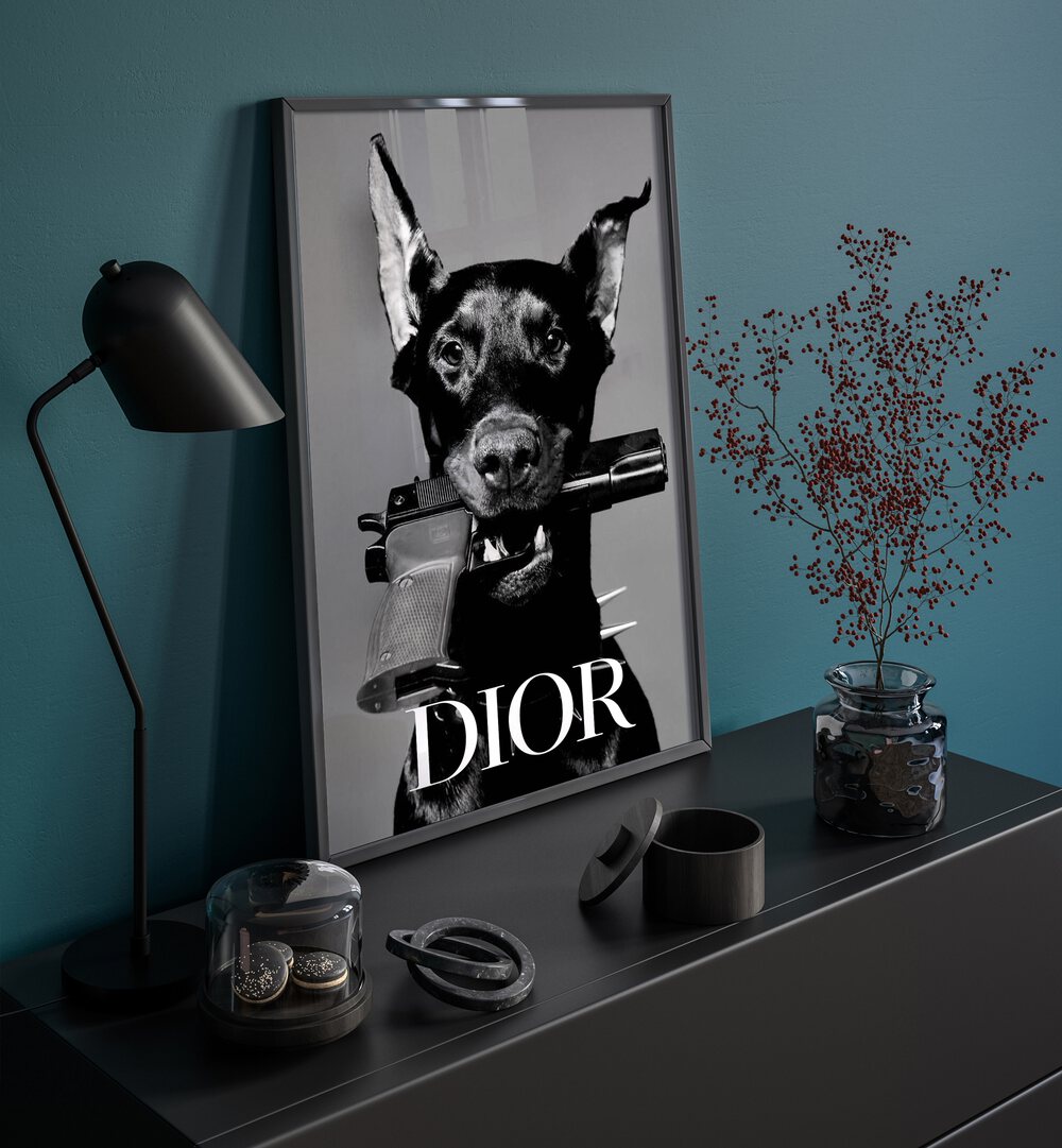 Dior Fashion Art Painting Artwork in plain black frame on a black console table beside a lamp
