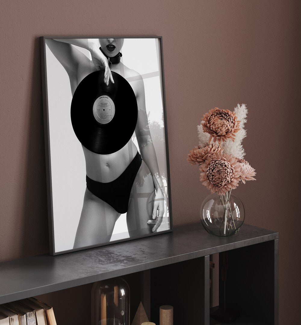 Death Ride by David Drake Fine Art Photography Fashion Photography in Black Plain Frame placed on a table beside a flower pot