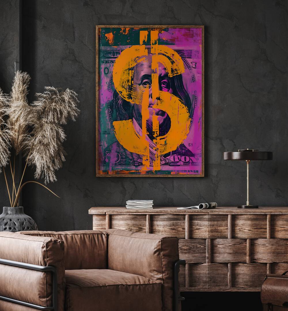 Dollar Pop Art Money Art in Oak Wood Plain Frame placed on a Dark Grey Colored Wall above a Console Table near a Brown  Sofa Chair in the Living Room