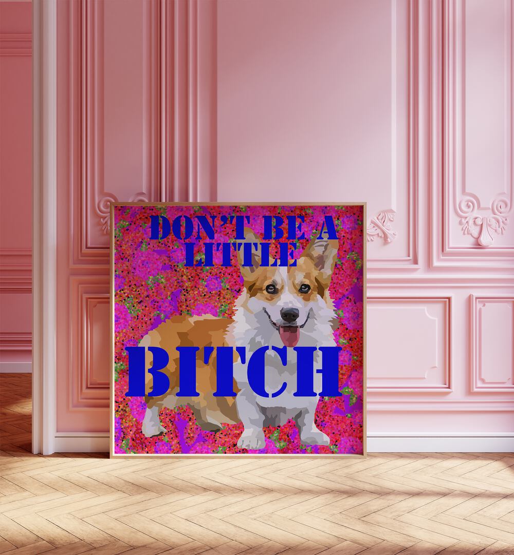 Dont Be a Little Bitch I By Lynnda Rakos Pop Art Paintings Pop Art Prints in Oak Wood Plain Frame placed on the floor beside a window