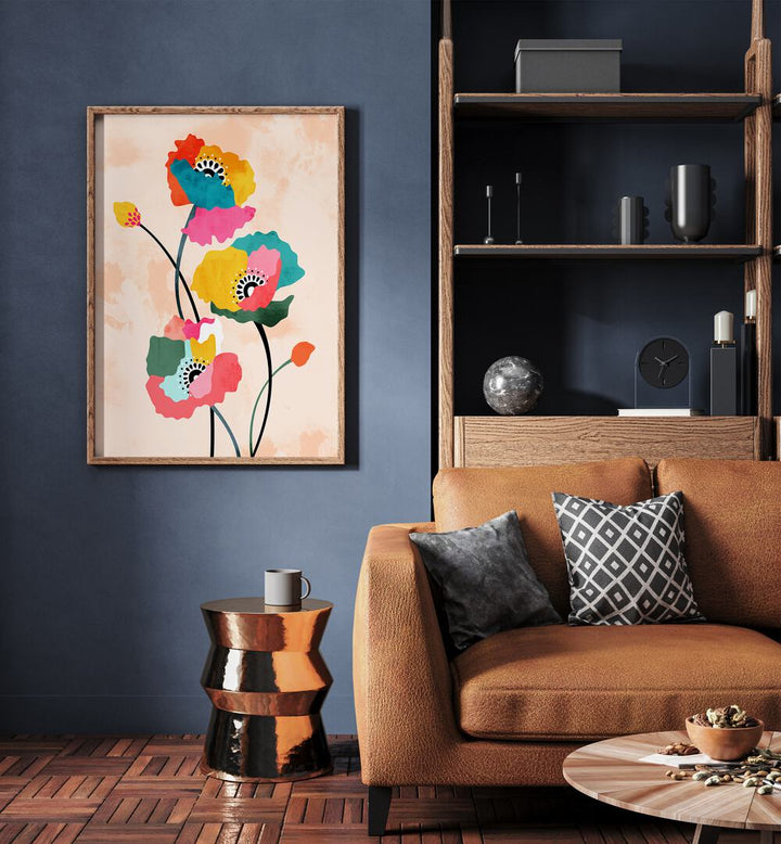 Dopamine Floral By Uma Gokhale Botanical Paintings in Oak Wood Plain Frame on a blue wall behind a sofa