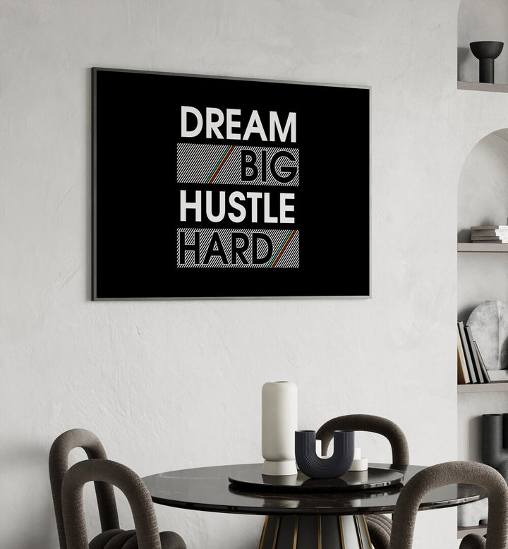 Dream Big Hustle Hard Quotes and Typography Posters in Black Plain Frame placed in a dining room behind a dining table