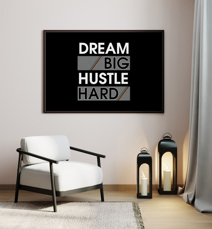 Dream Big Hustle Hard Quotes and Typography Posters in Black Plain Frame placed on a wall beside a chair