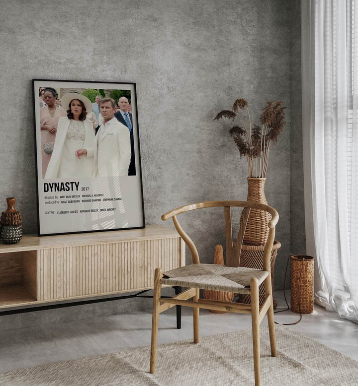 Dynasty 2017 i Movie Posters in Black Plain Frame placed on a table beside oakwood chair