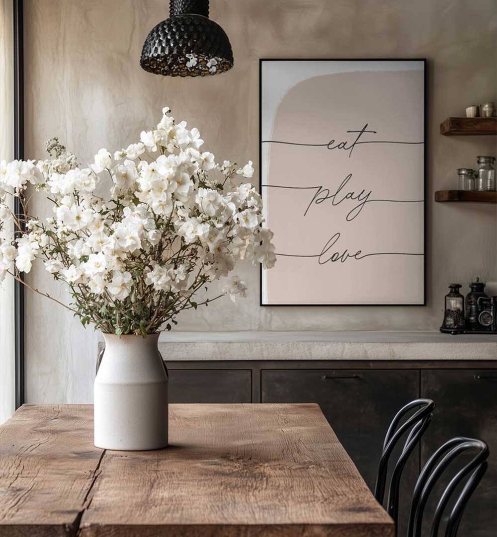 EAT PLAY LOVE , QUOTES framed typography poster above rustic dining table with vase of white flowers