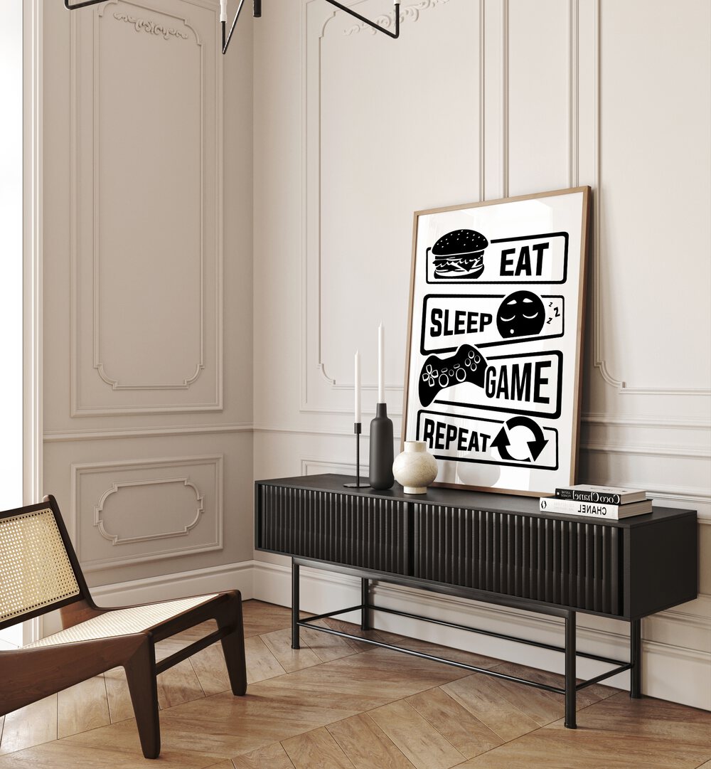 Eat Sleep Game Repeat III Gaming Art Painting Artwork in plain oakwood frame on black table behind candle stand