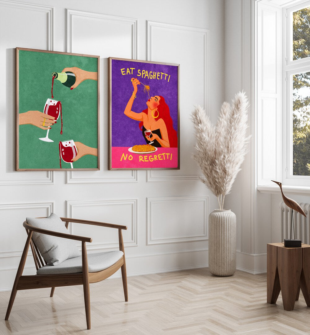 
"Modern dining room interior with a sleek black table, gray upholstered chairs, and a vibrant set of two framed wall art pieces. The artwork includes a green print of wine being poured and a colorful 'Eat Spaghetti No Regretti' illustration, adding bold personality and playful charm to the dark-toned space. Perfect for contemporary home decor inspiration."