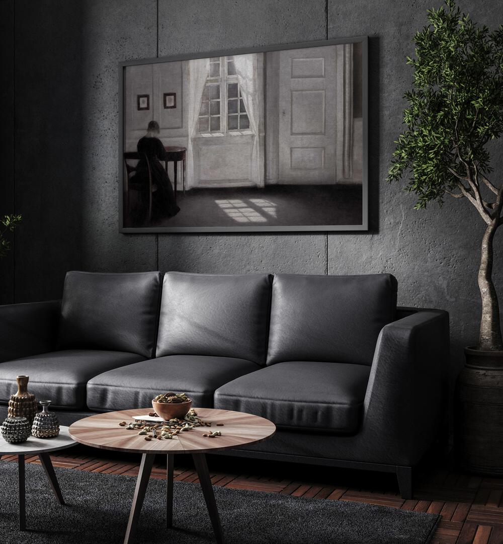 Echoes Of Solitude Gothic Wall Art Prints in Black Plain Frame hanging on a wall above black leather couch beside a plant.