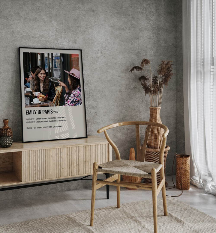 Emily In Paris 2020 i Movie Posters in Black Plain Frame placed on a table beside oakwood chair