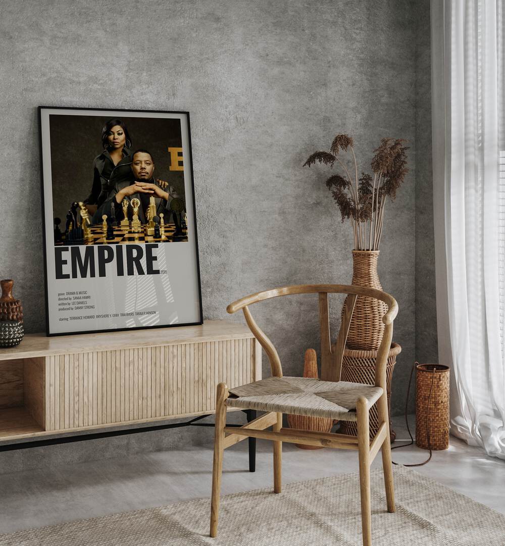 Empire 2015 I Movie Posters in Black Plain Frame placed on a table beside oakwood chair