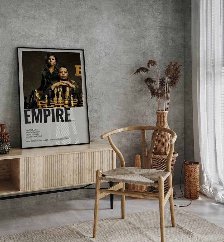 Empire 2015 I Movie Posters in Black Plain Frame placed on a table beside oakwood chair