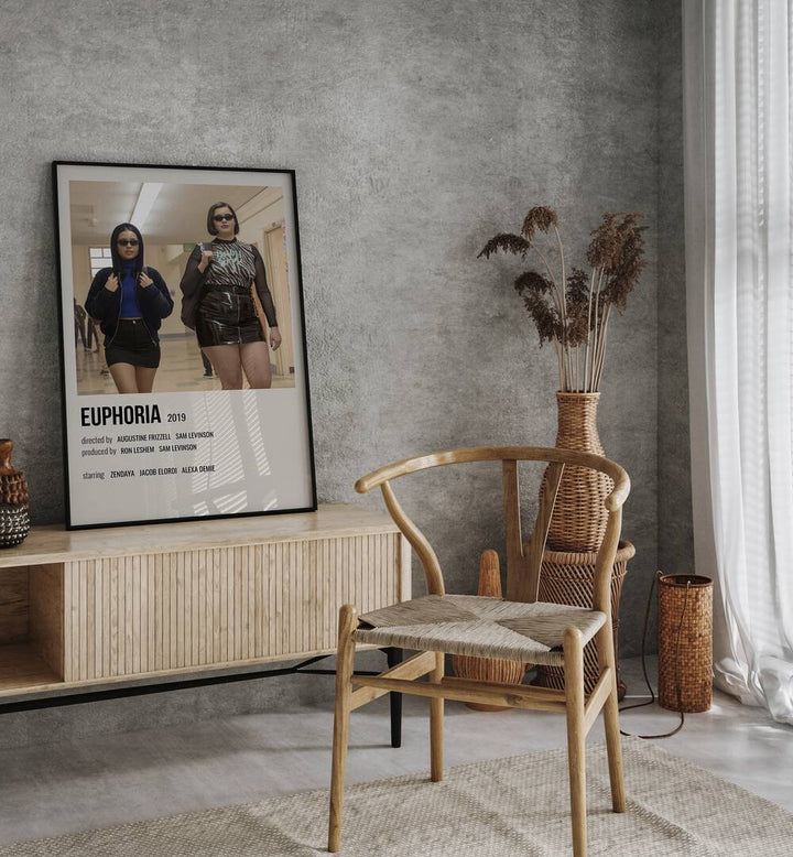 Euphoria 2019 II Movie Posters in Black Plain Frame placed on a console behind a chair