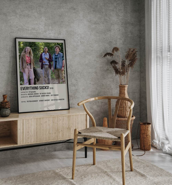 Everything Sucks 2018 II Movie Posters in Black Plain Frame placed on a console behind a chair
