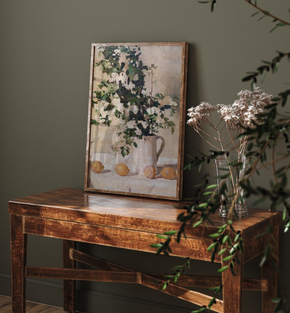 Flowers And Lemons Vintage Art Painting Artwork in plain oakwood frame on a wooden table beside a flower pot