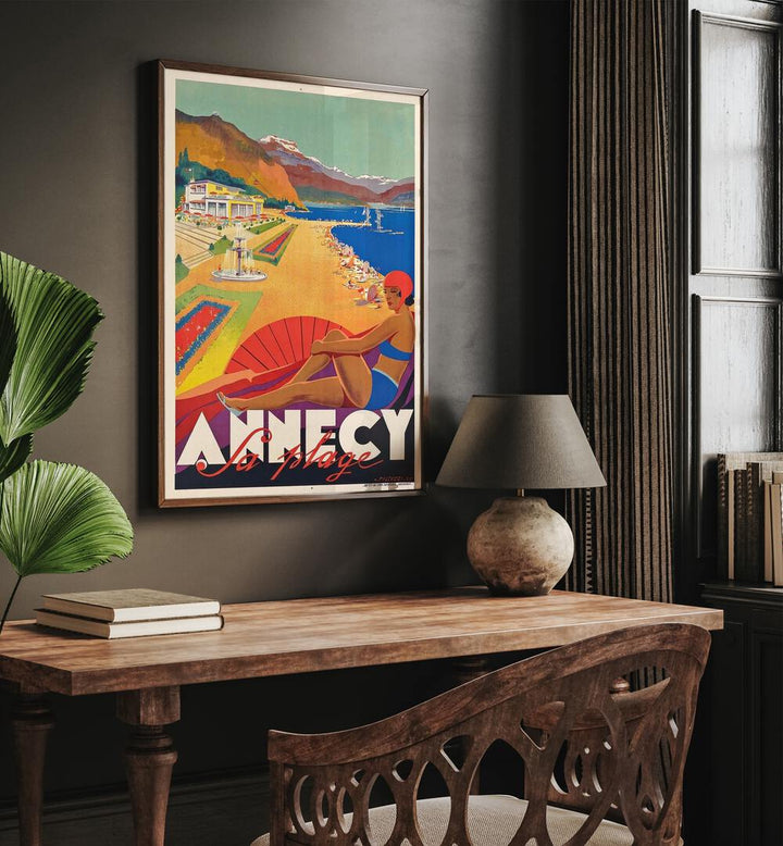 Fa Plage-Anncy Retro Vintage Travel Travel Posters in Dark Wood Plain Frame on a wall above a study table beside a lamp