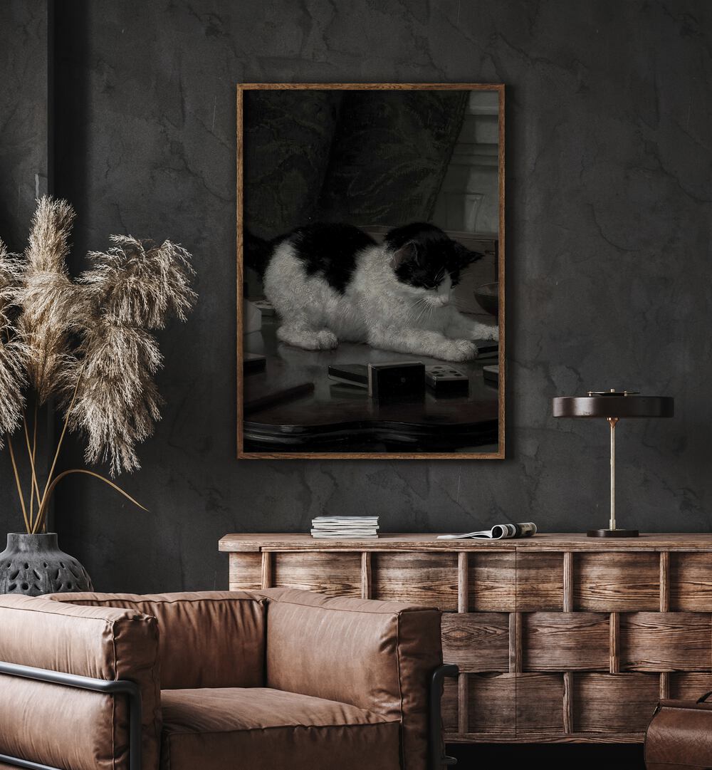 Feline Majesty The Enigmatic Cat Gothic Art Prints in Oak Wood Plain Frame hanging on wall above brown chair beside plant.