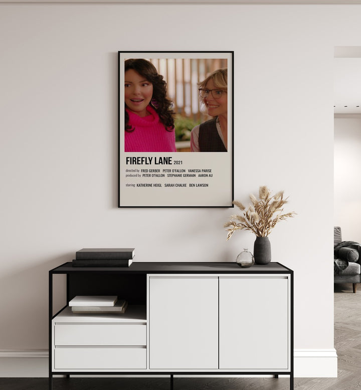 Firefly Lane 2021 Movie Posters in Black Plain Frame placed on a white wall behind a black and white table