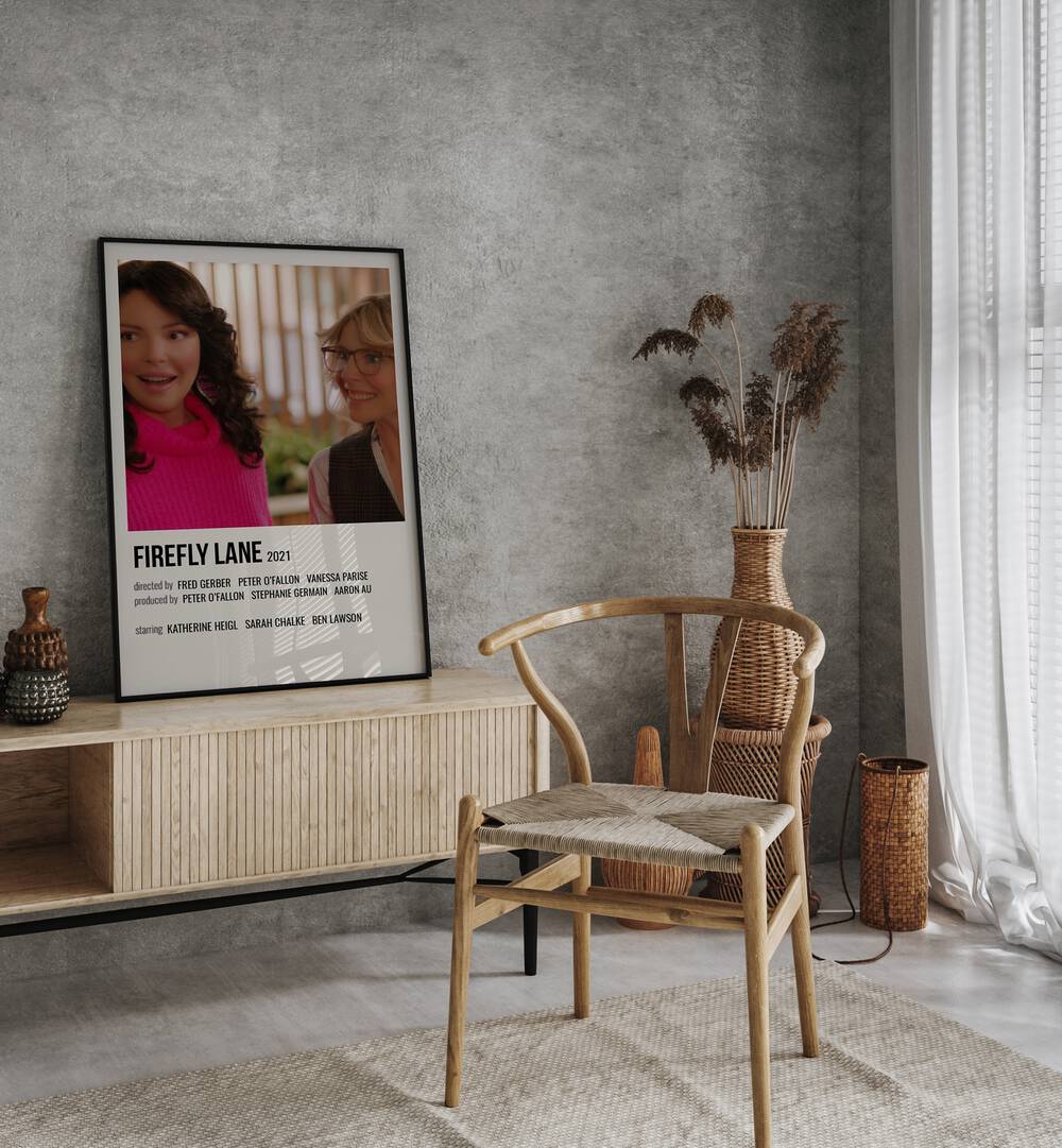 Firefly Lane 2021 Movie Posters in Black Plain Frame placed on a console behind a chair