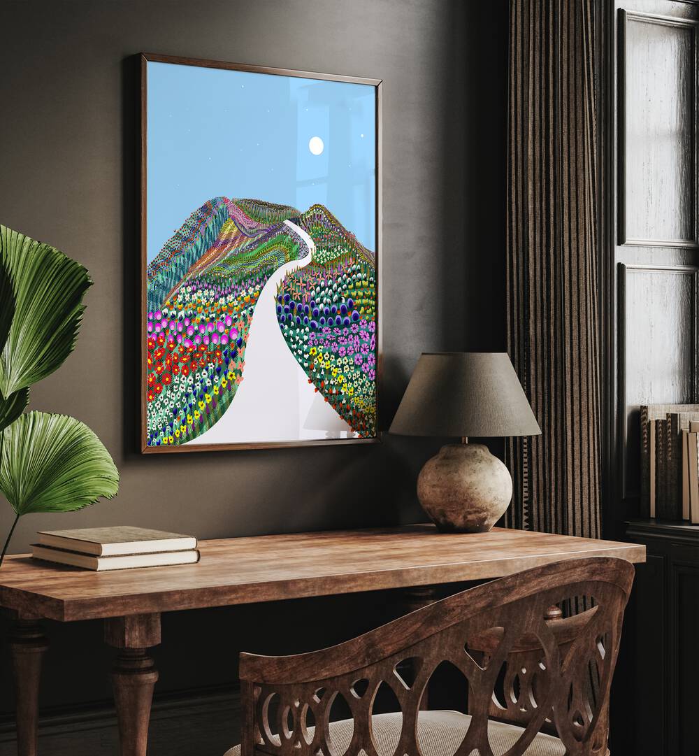 First Blossom By Uma Gokhale Landscape Art Prints in Dark wood frame on wall above  a study table