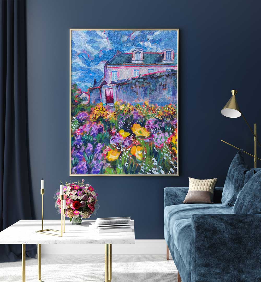FLEURS , LANDSCAPE PAINTINGS: framed floral landscape of cottage and vibrant garden hanging above navy living room sofa