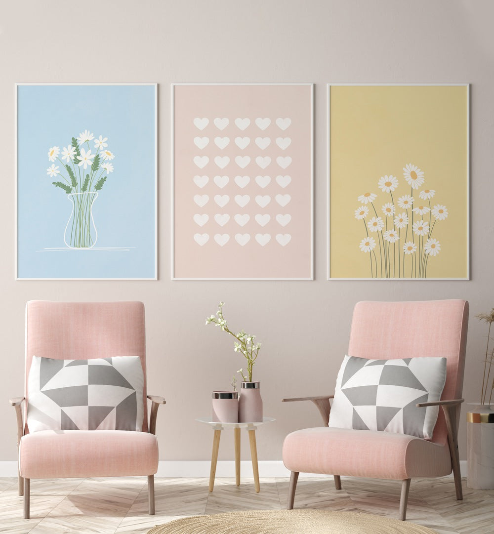 Flower Silhouettes Set Of 3 Paintings in White Plain Frame placed on a wall  behind pink chairs