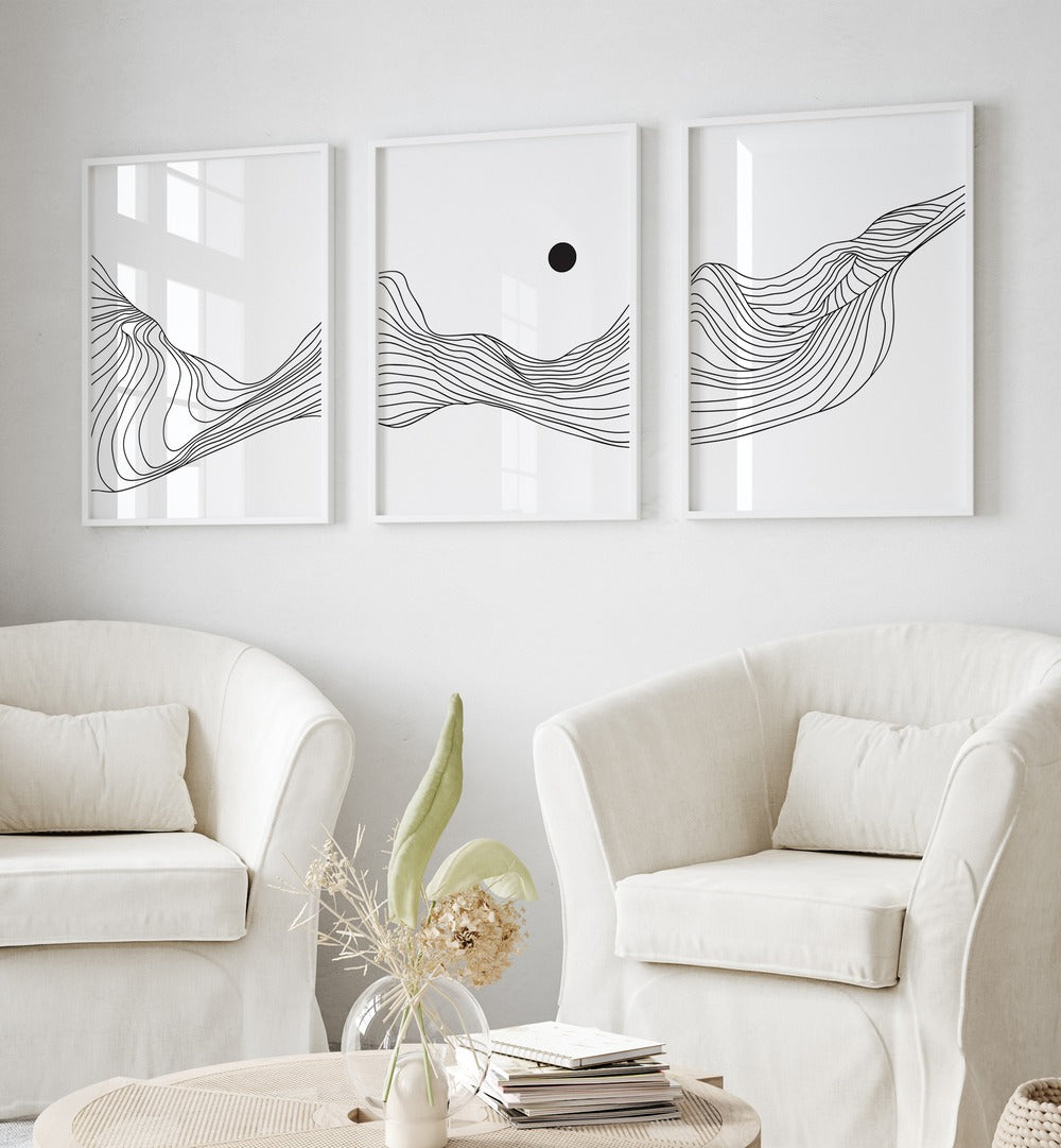 Fluidic Dunes Set Set Of 3 Paintings in White Plain Frame placed on a white wall behind two white chairs