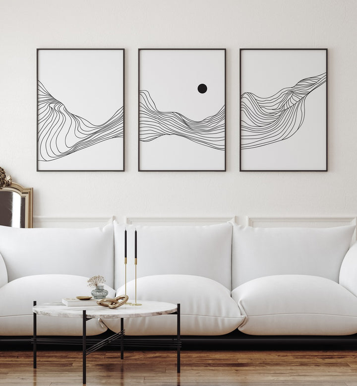 Fluidic Dunes Set Set Of 3 Paintings in Black Plain Frame placed on a living room wall behind a white sofa