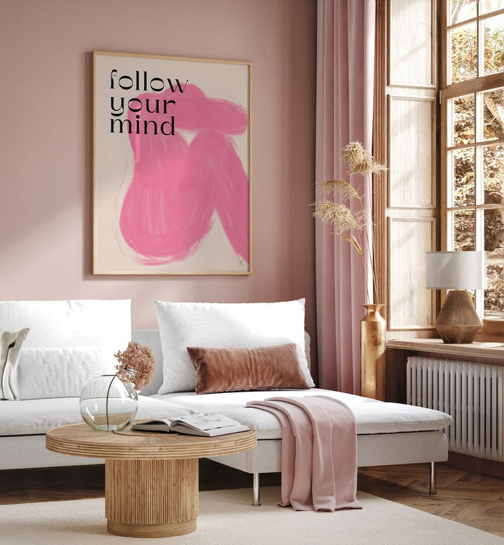 Follow Your Mind by Anne-marie Volfova Quotes and Typography Posters in Oak Wood Plain Frame placed on a living room wall behind a sofa and beside a window