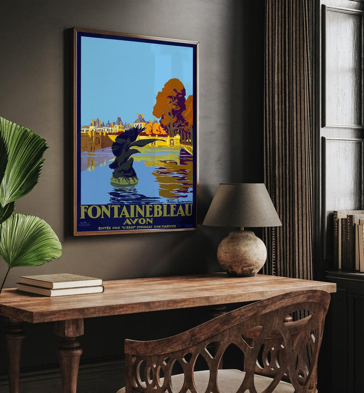 Fontainebleau-Avon Retro Vintage Travel Travel Posters in Dark Wood Plain Frame on a wall above a study table beside a lamp