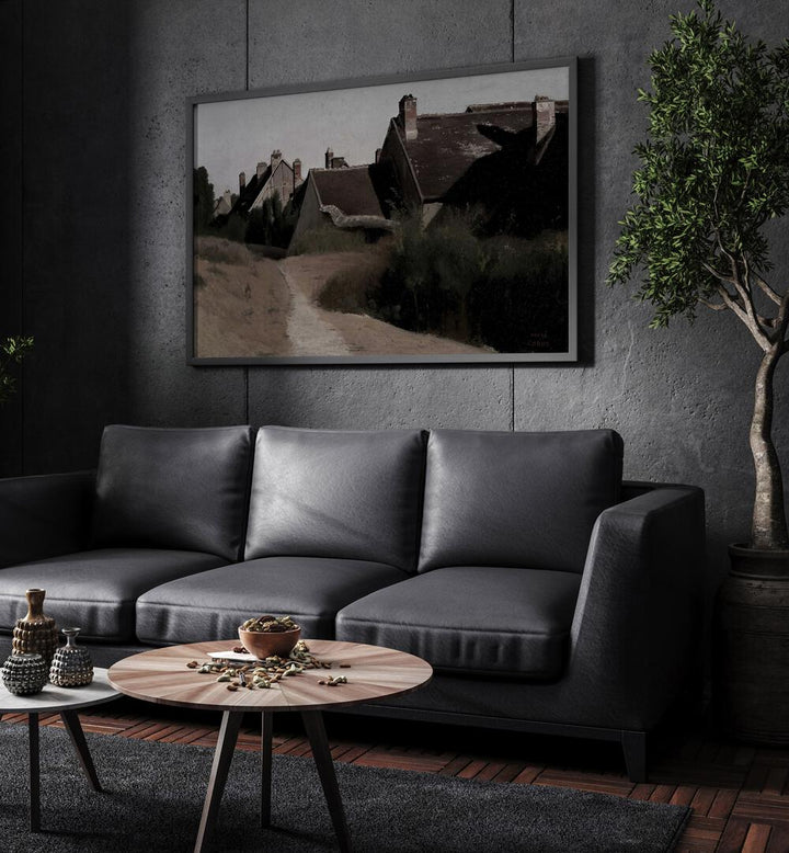 Forgotten Hamlet Gothic Wall Art Prints in Black Plain Frame hanging on a wall above black leather couch beside a plant.